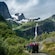 A group of people in a troll to car driving to the Briksdal Glacier in Briksdalen, Norway
